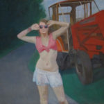 Girl posing beside a tractor